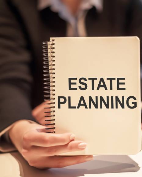 Business woman holding a notebook with the text Estate Planning