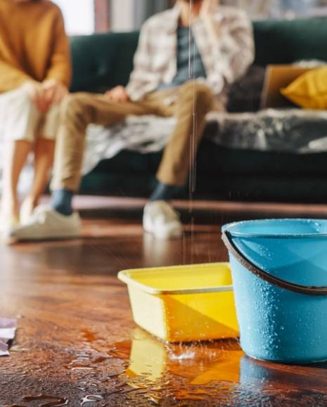 Roof is Leaking, Pipe Rupture at Home Water Drips into Buckets in Living Room.