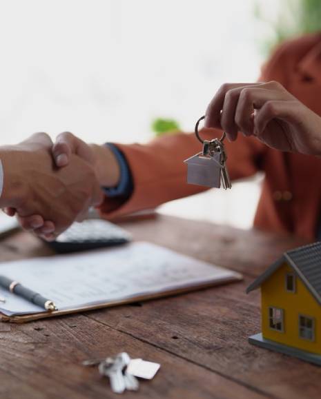 Business people sealing a real estate agreement with a handshake, symbolizing a successful partnership
