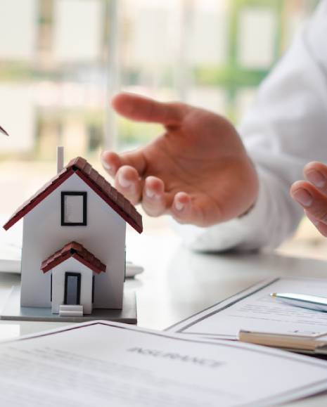 The real estate agent is explaining the house style to the clients who come to contact to see the house design and the purchase agreement.